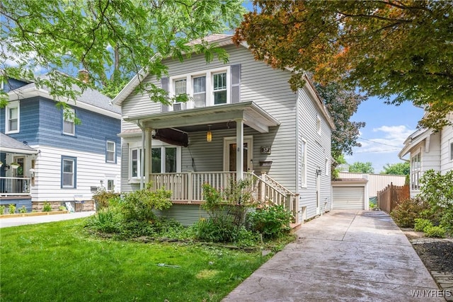 39 Colonial Ave, Lancaster, NY 14086 - view of front of house featuring a porch, a front yard, an outdoor structure, and a detached garage