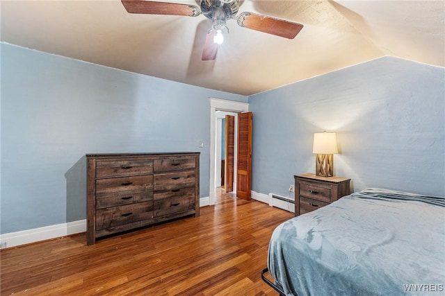39 Colonial Ave, Lancaster, NY 14086 - bedroom with wood finished floors, vaulted ceiling, baseboard heating, and a ceiling fan