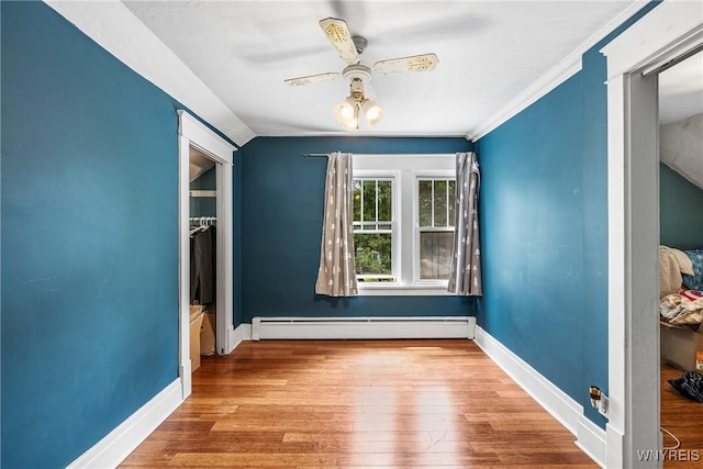 39 Colonial Ave, Lancaster, NY 14086 - spare room featuring a baseboard radiator, wood finished floors, and a ceiling fan