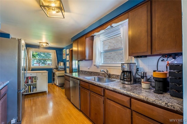 21 Niagara Cir, North Tonawanda, NY 14120 - kitchen featuring stainless steel appliances, light wood finished floors, brown cabinets, and dark countertops