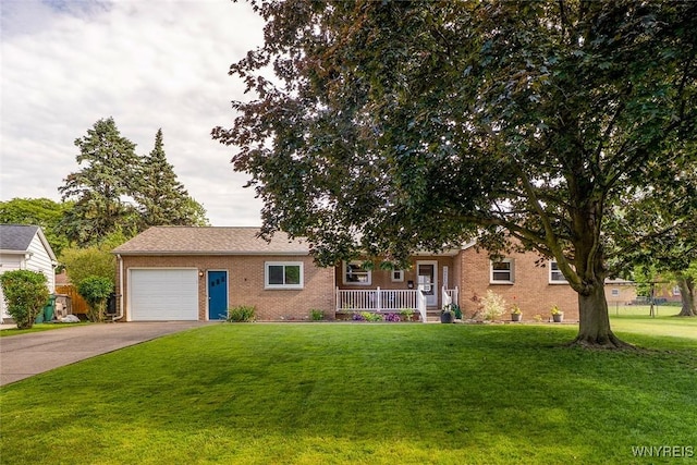 21 Niagara Cir, North Tonawanda, NY 14120 - view of front facade with covered porch, brick siding, an attached garage, a front yard, and concrete driveway