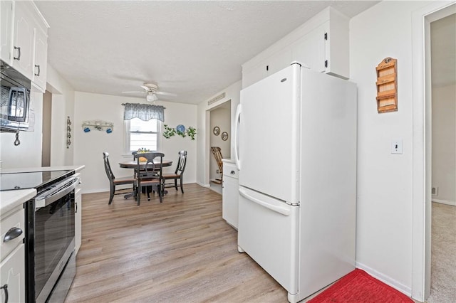 975 Whitlock Rd, Irondequoit, NY 14609 - kitchen with stainless steel appliances, ceiling fan, white cabinetry, light wood-type flooring, and light countertops