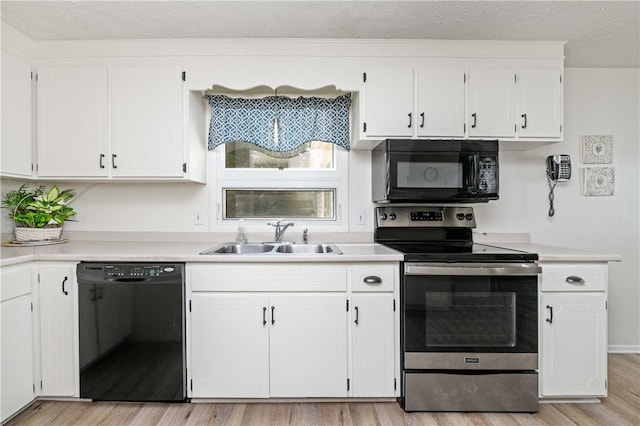 975 Whitlock Rd, Irondequoit, NY 14609 - kitchen with black appliances, white cabinetry, light wood-style flooring, light countertops, and a textured ceiling