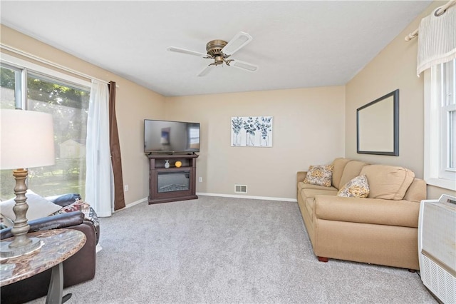 975 Whitlock Rd, Irondequoit, NY 14609 - carpeted living room featuring a glass covered fireplace and a ceiling fan