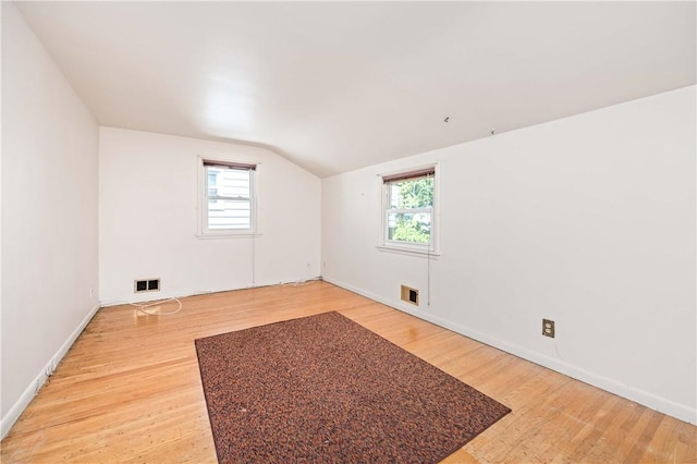 975 Whitlock Rd, Irondequoit, NY 14609 - additional living space with lofted ceiling, healthy amount of natural light, and light wood-type flooring