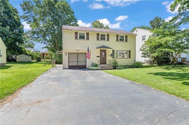 975 Whitlock Rd, Irondequoit, NY 14609 - view of front of home with driveway, a garage, a front lawn, and a shed