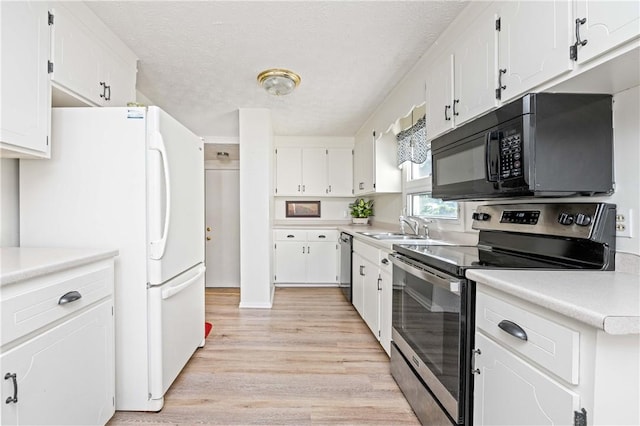 975 Whitlock Rd, Irondequoit, NY 14609 - kitchen with appliances with stainless steel finishes, light wood-style flooring, white cabinetry, light countertops, and a textured ceiling