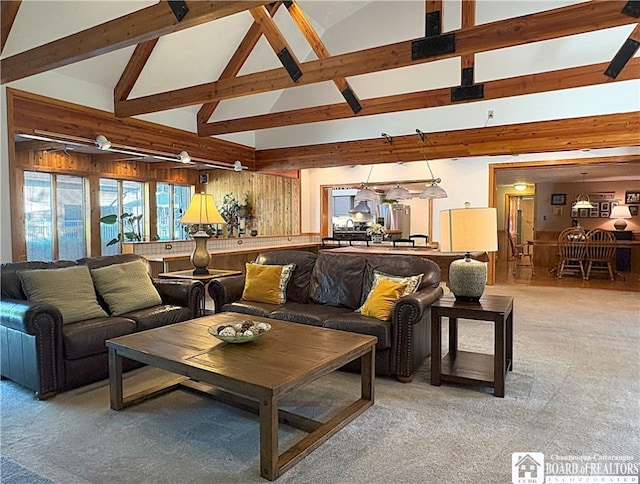 24 W 2nd St, Westfield, NY 14787 - living room with high vaulted ceiling, light carpet, beamed ceiling, and wooden walls