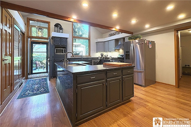 24 W 2nd St, Westfield, NY 14787 - kitchen with stainless steel appliances, light wood-type flooring, an island with sink, recessed lighting, and wall chimney exhaust hood