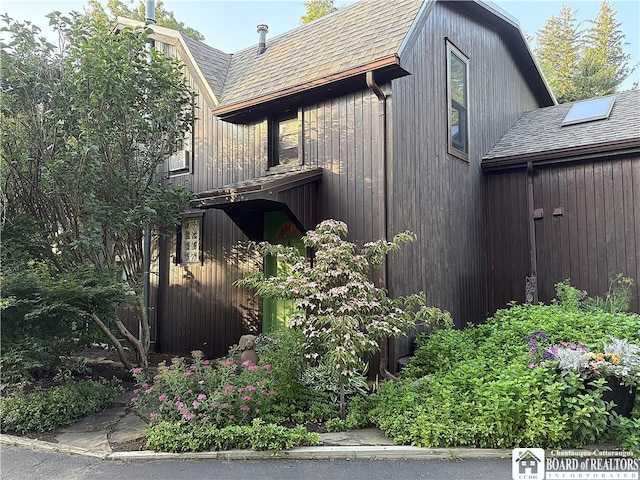 24 W 2nd St, Westfield, NY 14787 - view of side of home featuring roof with shingles