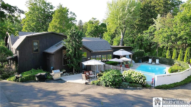 24 W 2nd St, Westfield, NY 14787 - view of pool featuring a patio area, an outdoor hangout area, and view of wooded area