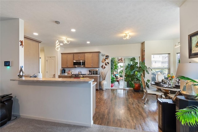 37 Etherington Cres, Chili, NY 14428 - kitchen featuring stainless steel appliances, a peninsula, recessed lighting, pendant lighting, and brown cabinetry