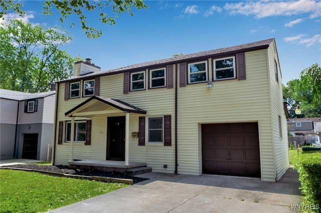 1335 James Ave, Niagara Falls, NY 14305 - view of front of property with a chimney, a garage, and concrete driveway