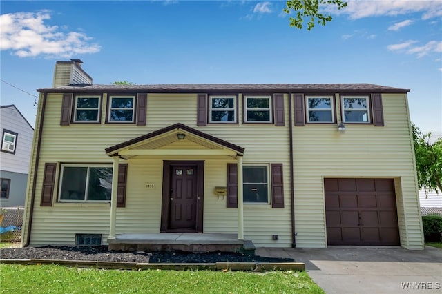 1335 James Ave, Niagara Falls, NY 14305 - view of front of home with an attached garage, a chimney, and concrete driveway