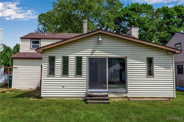 1335 James Ave, Niagara Falls, NY 14305 - rear view of property featuring entry steps, a yard, and a chimney