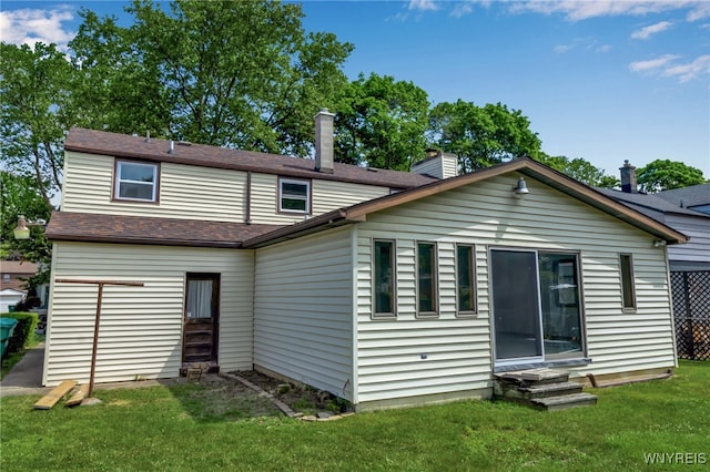1335 James Ave, Niagara Falls, NY 14305 - rear view of house with entry steps, a lawn, a chimney, and a shingled roof