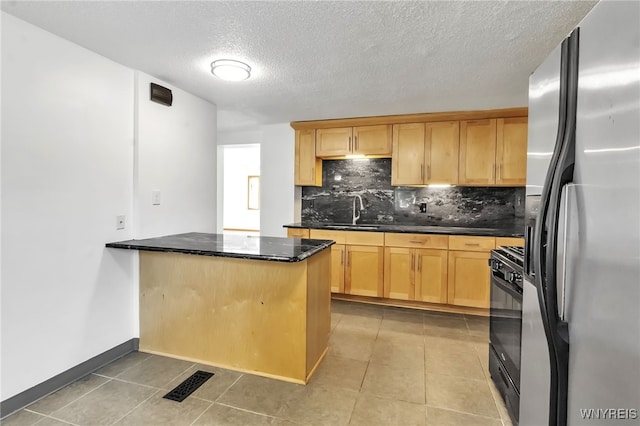 1335 James Ave, Niagara Falls, NY 14305 - kitchen with stainless steel refrigerator with ice dispenser, backsplash, light tile patterned floors, black gas stove, and a textured ceiling
