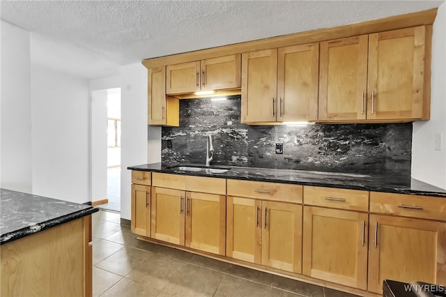 1335 James Ave, Niagara Falls, NY 14305 - kitchen featuring backsplash, dark stone counters, light tile patterned floors, and a textured ceiling