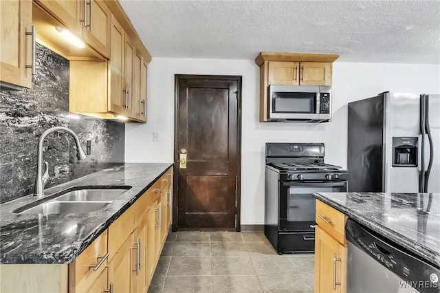 1335 James Ave, Niagara Falls, NY 14305 - kitchen with stainless steel appliances, backsplash, dark stone countertops, light brown cabinets, and a textured ceiling