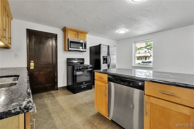 1335 James Ave, Niagara Falls, NY 14305 - kitchen featuring stainless steel appliances, light brown cabinetry, a textured ceiling, light tile patterned flooring, and dark stone counters