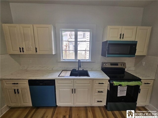 901 W Henley St, Olean, NY 14760 - kitchen with black microwave, dishwasher, electric stove, wood finished floors, and light stone counters