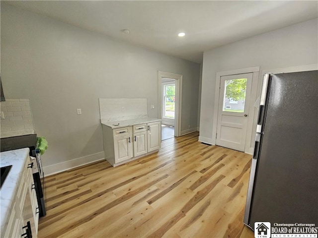 901 W Henley St, Olean, NY 14760 - kitchen with freestanding refrigerator, light wood finished floors, light stone counters, recessed lighting, and a fireplace