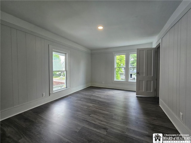 901 W Henley St, Olean, NY 14760 - spare room with dark wood-style floors, a decorative wall, and recessed lighting