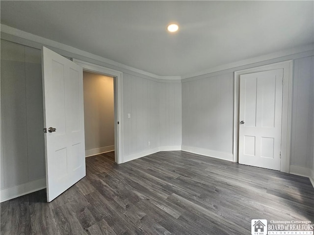 901 W Henley St, Olean, NY 14760 - unfurnished bedroom featuring baseboards and dark wood finished floors