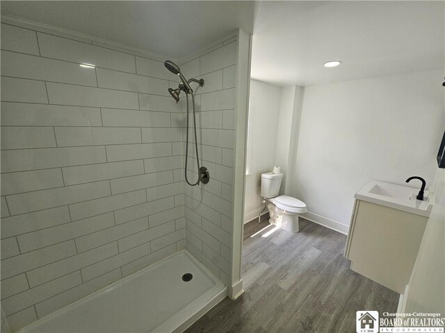 901 W Henley St, Olean, NY 14760 - bathroom featuring vanity, wood finished floors, tiled shower, and recessed lighting