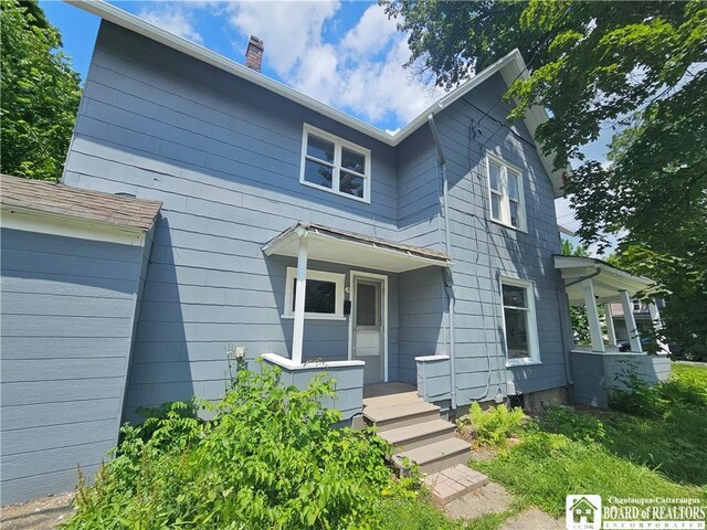 901 W Henley St, Olean, NY 14760 - view of front of house with a chimney