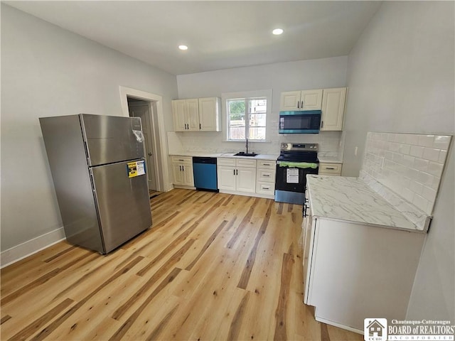 901 W Henley St, Olean, NY 14760 - kitchen with stainless steel appliances, light wood finished floors, decorative backsplash, recessed lighting, and light stone countertops