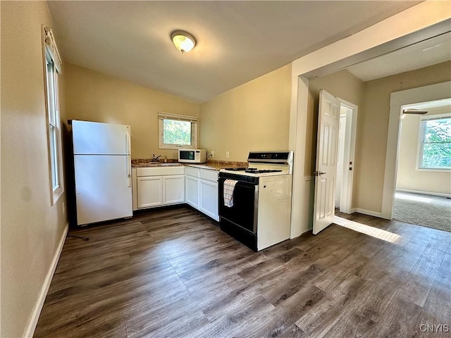 352 Sloperville Rd, Albion, NY 13302 - kitchen featuring white appliances, healthy amount of natural light, white cabinetry, dark wood-type flooring, and vaulted ceiling