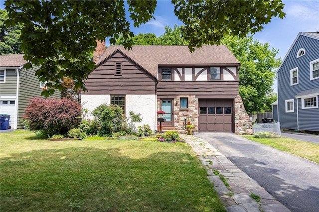 54 Covington Rd, Irondequoit, NY 14617 - view of front facade featuring a chimney, asphalt driveway, a front lawn, and stone siding