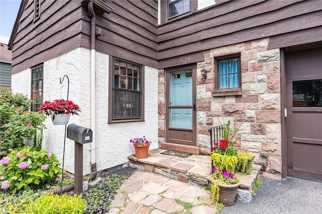 54 Covington Rd, Irondequoit, NY 14617 - view of exterior entry featuring stucco siding