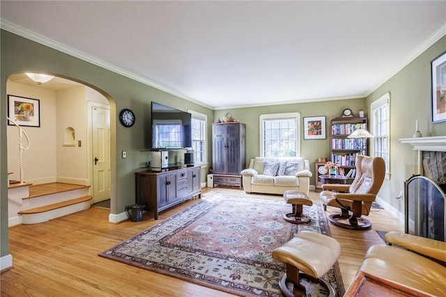 54 Covington Rd, Irondequoit, NY 14617 - living room with arched walkways, crown molding, light wood-type flooring, and a fireplace