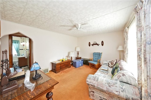 6167 N Whitham Dr, Niagara, NY 14304 - carpeted living room with arched walkways and a ceiling fan