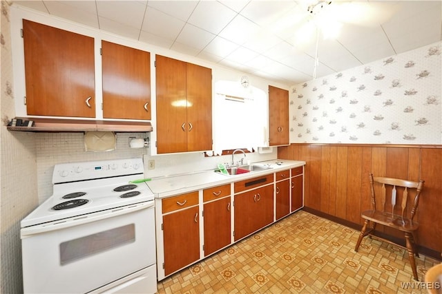 6167 N Whitham Dr, Niagara, NY 14304 - kitchen featuring white electric range oven, wallpapered walls, light countertops, wainscoting, and brown cabinetry