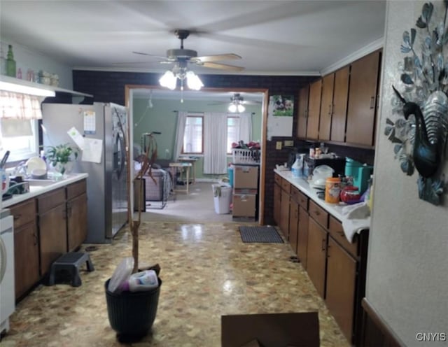 30 Wilson St, Gouverneur, NY 13642 - kitchen featuring stainless steel fridge, light countertops, ceiling fan, and ornamental molding