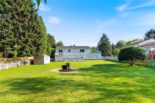 1535 Bluestem Ct, Walworth, NY 14568 - fenced backyard with a shed, an outdoor fire pit, a deck, and stairs