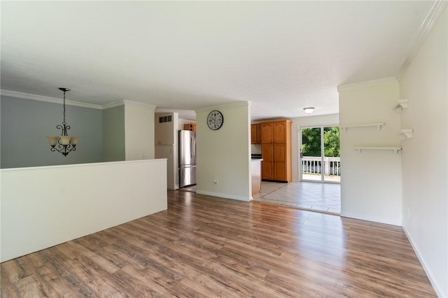 1535 Bluestem Ct, Walworth, NY 14568 - unfurnished living room featuring light wood finished floors, a chandelier, and ornamental molding
