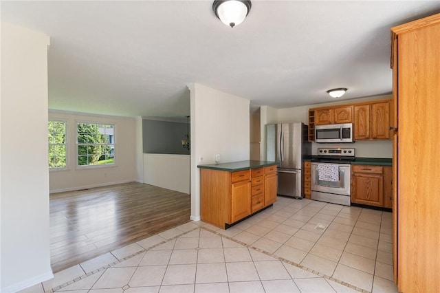 1535 Bluestem Ct, Walworth, NY 14568 - kitchen featuring stainless steel appliances, dark countertops, brown cabinetry, open floor plan, and light tile patterned flooring