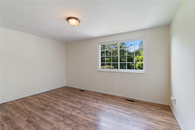 1535 Bluestem Ct, Walworth, NY 14568 - spare room featuring wood finished floors