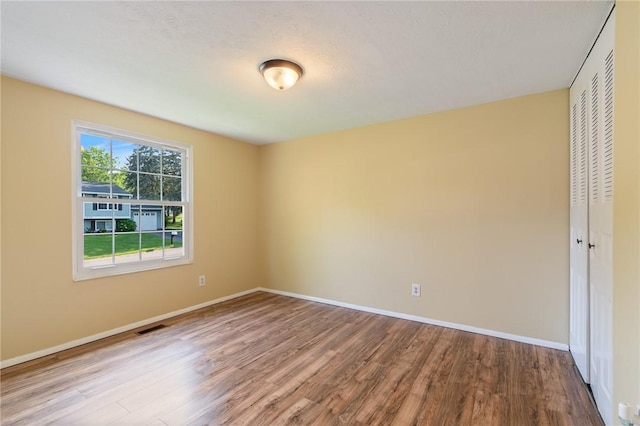 1535 Bluestem Ct, Walworth, NY 14568 - unfurnished room featuring wood finished floors and baseboards