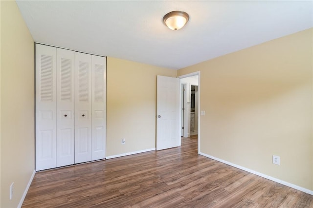 1535 Bluestem Ct, Walworth, NY 14568 - unfurnished bedroom featuring wood finished floors and a closet