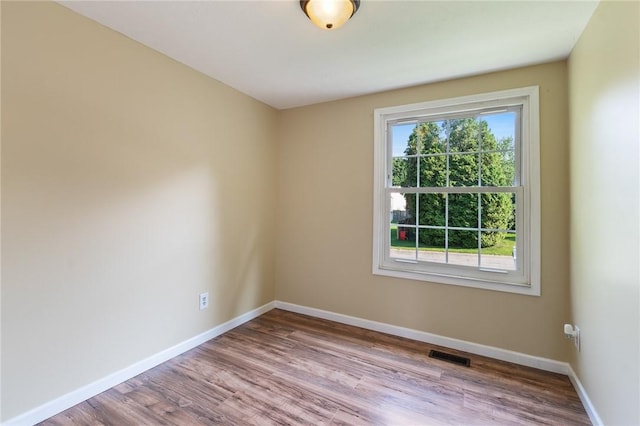 1535 Bluestem Ct, Walworth, NY 14568 - spare room with baseboards and wood finished floors