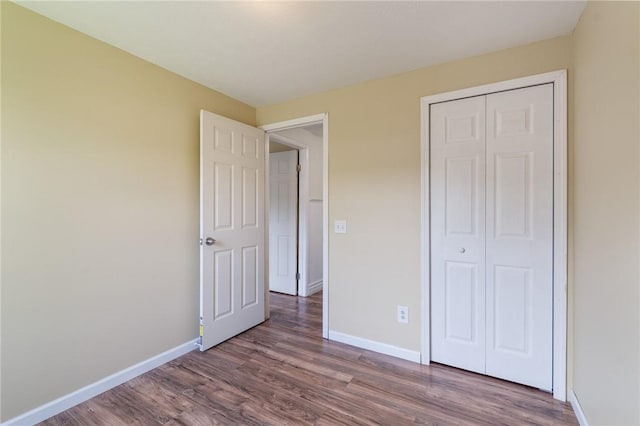 1535 Bluestem Ct, Walworth, NY 14568 - unfurnished bedroom featuring wood finished floors and a closet