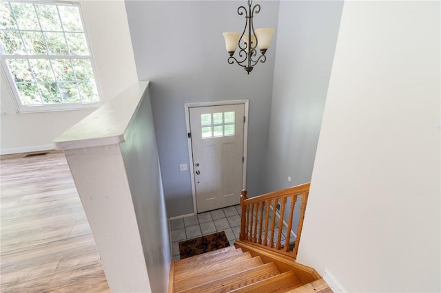 1535 Bluestem Ct, Walworth, NY 14568 - foyer entrance featuring a chandelier and stairway
