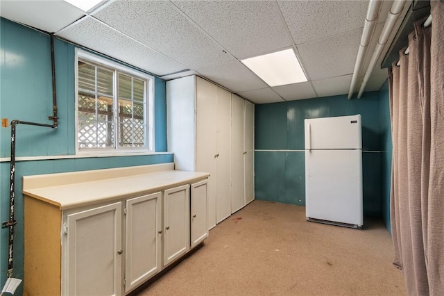 1535 Bluestem Ct, Walworth, NY 14568 - below grade area featuring freestanding refrigerator, a drop ceiling, and light carpet