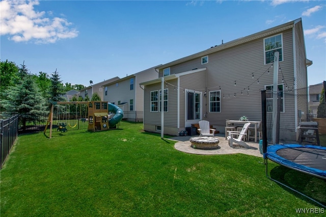 5 Scooter Ln, Hamburg, NY 14075 - back of house with a trampoline, a playground, a patio area, a fenced backyard, and a fire pit
