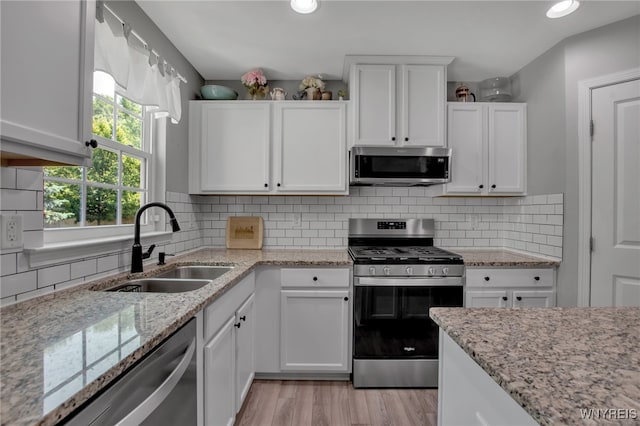 5 Scooter Ln, Hamburg, NY 14075 - kitchen with stainless steel appliances, white cabinets, light wood-style floors, backsplash, and recessed lighting